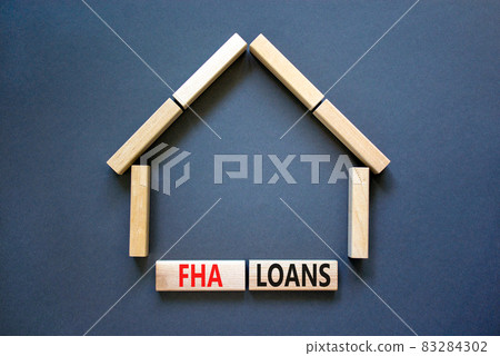 FHA federal housing administration loans symbol. Concept words 'FHA federal housing administration loans' on wooden blocks on a beautiful grey background. Business and FHA loans concept. Copy space. 83284302