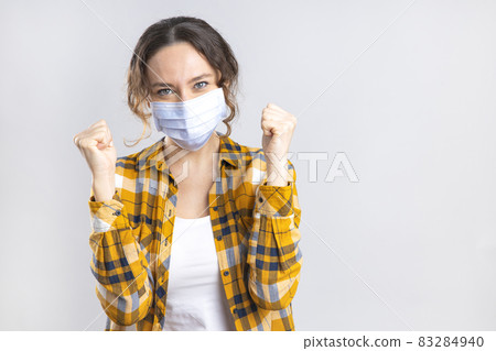 Young happy woman wearing hygienic mask to prevent infection coronavirus 83284940