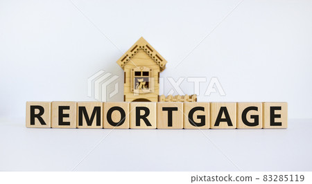 Remortgage symbol. Wooden cubes form the word 'remortgage' near miniature house. Beautiful white background, copy space. Business and remortgage concept. 83285119