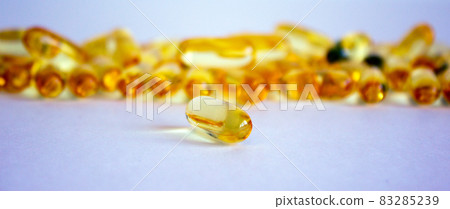 Yellow vitamins tablets, fish oil, Omega Vitamin E. Pills on a white background. Web banner with a copy space. Yellow vitamins tablets, fish oil, Omega Vitamin E. Pills on a white background. Web banner with a copy space. 83285239