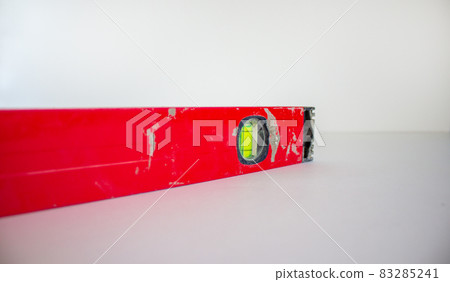 Building tool level. Red water level tool isolated on white background. Concept. Copy space. Building tool level. Red water level tool isolated on white background. Concept. Copy space. 83285241