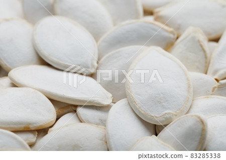 Pumpkin seeds in a shell as a textural background. Pumpkin seeds in a shell as a textural background. 83285338