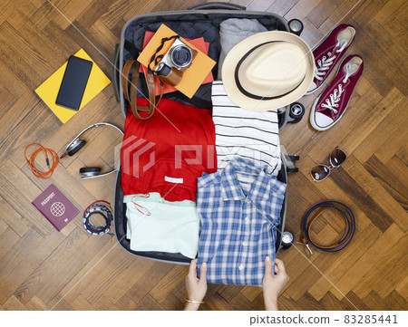 Close-up of woman preparing luggage 83285441