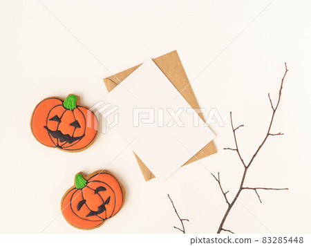 Empty white postcard and craft envelope and Halloween gingerbread cookies Jack O'Lanterns on white background. Halloween concept. Top view. Copy space Empty white postcard and craft envelope and Halloween gingerbread cookies Jack O'Lanterns on white background. Halloween concept. Top view. Copy space 83285448
