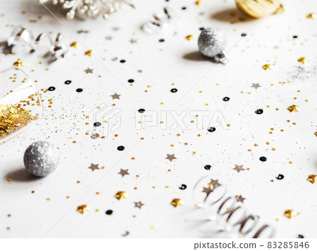 Flat lay of Christmas or New Year, gold and silver party season decorations on white background. 83285846