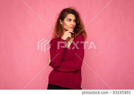Photo of young european thoughtful charming cute brunette curly woman with sincere emotions wearing 83285905