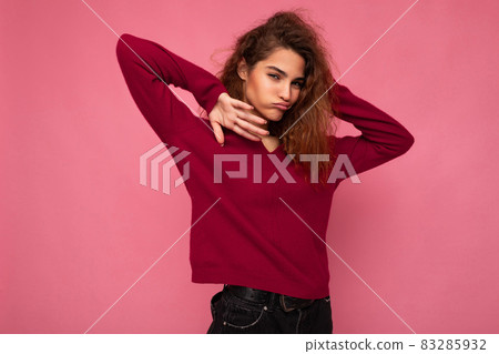Portrait of young positive happy joyful beautiful brunette curly woman with sincere emotions wearing Portrait of young positive happy joyful beautiful brunette curly woman with sincere emotions wearing 83285932