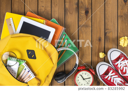 School backpack and school supplies on wooden background 83285992