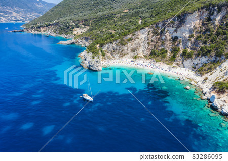 Aerial drone photo of iconic paradise sandy beach of Agiofili near port of Vasiliki with emerald crystal clear sea and sail boats docked, Lefkada island, Ionian, Greece Aerial drone photo of iconic paradise sandy beach of Agiofili near port of Vasiliki with emerald crystal clear sea and sail boats docked, Lefkada island, Ionian, Greece 83286095