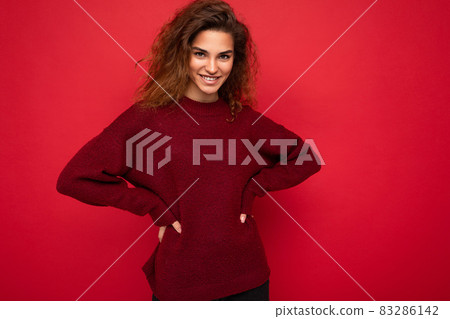 Photo of beautiful positive smiling adult woman wearing stylish clothes standing isolated on Photo of beautiful positive smiling adult woman wearing stylish clothes standing isolated on 83286142