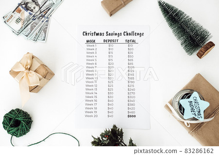 Christmas budget, Christmas Savings Challenge. Xmas savings, Savings challenge, Saving money concept with dollars bills and Savings Challenge list Christmas budget, Christmas Savings Challenge. Xmas savings, Savings challenge, Saving money concept with dollars bills and Savings Challenge list 83286162