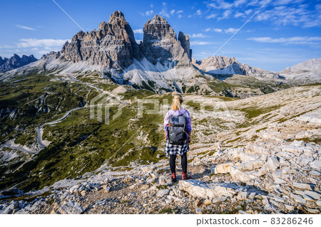 Woman hiker exploring Tre Cime di Lavaredo national park. Trentino-Alto-Adige, Dolomiti, Italy 83286246