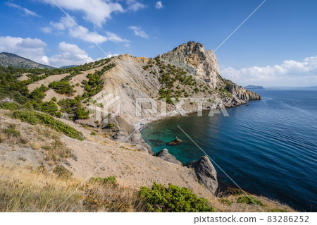 Summer Crimean landscape. Golitsyn trail at rocky Black Sea coast at sunny day, Novyi Svit, Sudak Municipality, Crimea 83286252