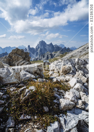Rifugio Lavaredo with Cadini di Misurina mountain group in background. Dolomites at the Cime di Lavaredo, Italy 83286308