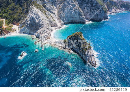 Aerial view Agia Eleni beach in Kefalonia Island, Greece. Remote beautiful rocky beach with clear emerald water and high white cliffs Aerial view Agia Eleni beach in Kefalonia Island, Greece. Remote beautiful rocky beach with clear emerald water and high white cliffs 83286329