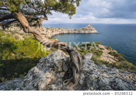 Mountains and sea are on background. Novyi Svit, Crimea, Sudak. Cape named Kapchik, sea is Black Sea. Beautiful landscape with views of the mountains, sea, forest Mountains and sea are on background. Novyi Svit, Crimea, Sudak. Cape named Kapchik, sea is Black Sea. Beautiful landscape with views of the mountains, sea, forest 83286512