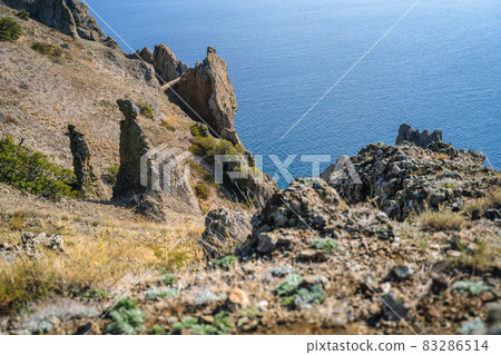 Fantastic stone pillars in the Karadag reserve, Crimea. View from the top of mountain in sanny day of golden autumn 83286514