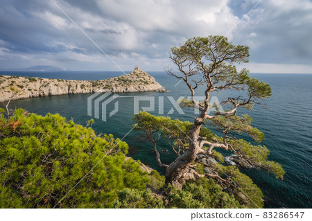 Mountains and sea are on background. Novyi Svit, Crimea, Sudak. Cape named Kapchik, sea is Black Sea. Beautiful landscape with views of the mountains, sea, forest Mountains and sea are on background. Novyi Svit, Crimea, Sudak. Cape named Kapchik, sea is Black Sea. Beautiful landscape with views of the mountains, sea, forest 83286547