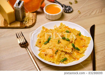 Homemade Pumpkin Ravioli with ricotta cheese served basil Homemade Pumpkin Ravioli with ricotta cheese served basil 83286699