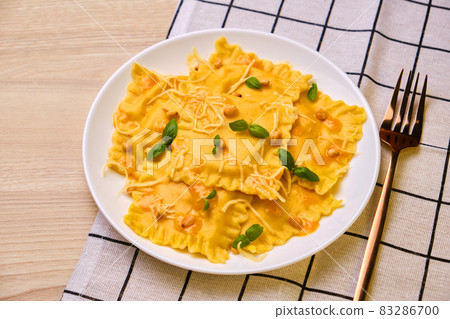 Homemade Pumpkin Ravioli with ricotta cheese served basil Homemade Pumpkin Ravioli with ricotta cheese served basil 83286700