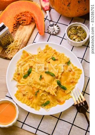 Homemade Pumpkin Ravioli with ricotta cheese served basil Homemade Pumpkin Ravioli with ricotta cheese served basil 83286701
