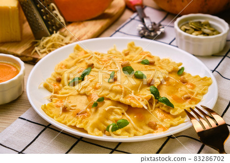 Homemade Pumpkin Ravioli with ricotta cheese served basil Homemade Pumpkin Ravioli with ricotta cheese served basil 83286702