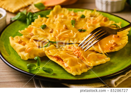 Homemade Pumpkin Ravioli with ricotta cheese served basil Homemade Pumpkin Ravioli with ricotta cheese served basil 83286727