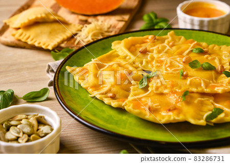 Homemade Pumpkin Ravioli with ricotta cheese served basil Homemade Pumpkin Ravioli with ricotta cheese served basil 83286731