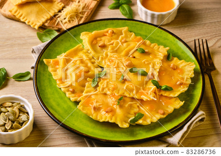 Homemade Pumpkin Ravioli with ricotta cheese served basil 83286736