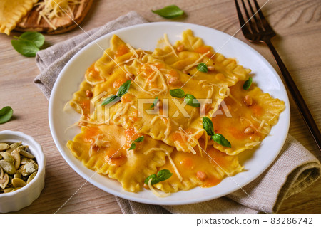 Homemade Pumpkin Ravioli with ricotta cheese served basil 83286742