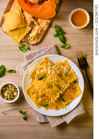 Homemade Pumpkin Ravioli with ricotta cheese served basil 83286745