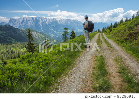 Traveler man on hiking trail enjoying Wilder Kaiser mountains, Tirol - Austria 83286915