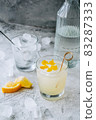 Citrus cocktail with lemon juice and decorated with lemon peel on the table. 83287333