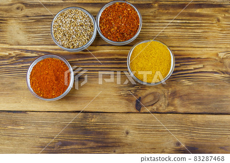 Set of different aromatic spices on wooden table. Top view 83287468