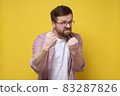 Aggressive bearded man with glasses clenched fists and started to defend himself with a funny 83287826