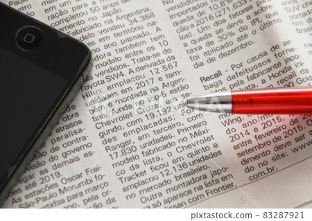 Foreign language newspaper, pen and smartphone business image Foreign language newspaper, pen and smartphone business image 83287921
