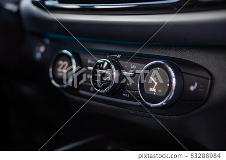 multimedia control console and climate in a modern car. close-up, selective focus, no people multimedia control console and climate in a modern car. close-up, selective focus, no people 83288984