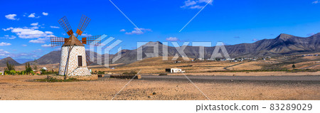 desert scenery with windmill. Fuerteventura island. Canary islands of Spain 83289029