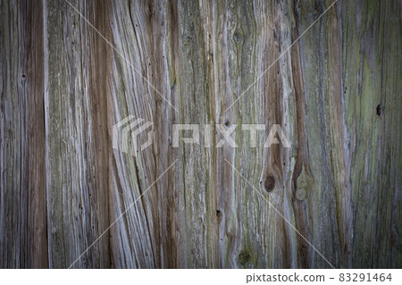 Wooden logs of an old house. Close-up. Weathered natural gray wood texture. Background. Horizontal photo. 83291464