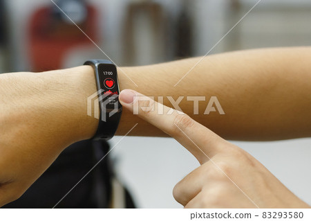 close up hand of woman point finger at smart watch checking measuring heart rate after exercise. close up hand of woman point finger at smart watch checking measuring heart rate after exercise. 83293580
