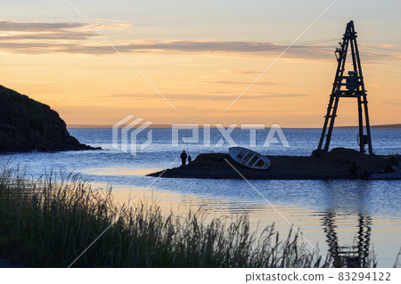 Beautiful evening landscape with fishermen on the river bank Beautiful evening landscape with fishermen on the river bank 83294122