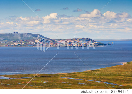 Aerial view of the tundra, estuary and a small northern city. Aerial view of the tundra, estuary and a small northern city. 83294125