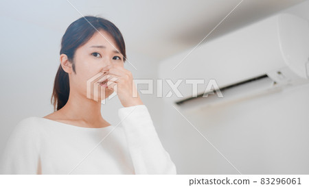 Image of a woman pinching her nose Image of a woman pinching her nose 83296061