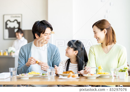 Young family eating out 83297076
