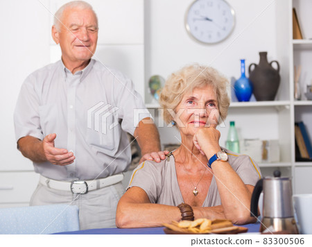 Elderly man trying to apologize to offended woman 83300506