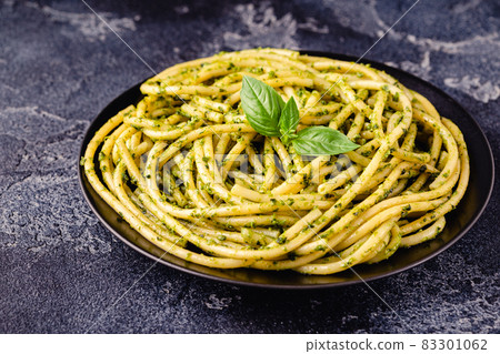 Pasta spaghetti with pesto sauce and fresh basil leaves Pasta spaghetti with pesto sauce and fresh basil leaves 83301062