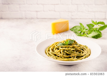 Pasta spaghetti with pesto sauce and fresh basil leaves Pasta spaghetti with pesto sauce and fresh basil leaves 83301063