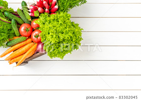 Overhead shot of vegetables in wooden box Overhead shot of vegetables in wooden box 83302045