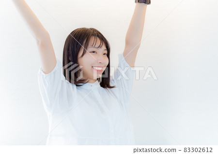 A woman who raises her arms with a smile 83302612