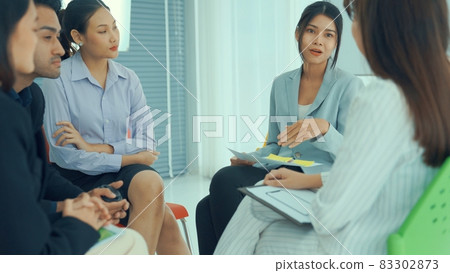 Business people proficiently discuss work project while sitting in circle Business people proficiently discuss work project while sitting in circle 83302873